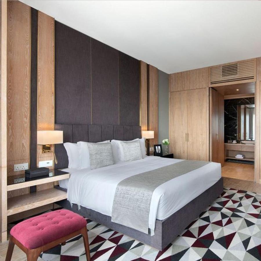 The Bentley Luxury Hotel & Suites Doha Exteriör bild A bedroom at the hotel