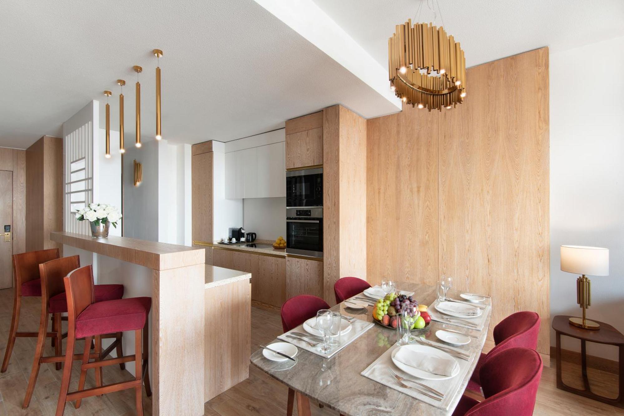 The Bentley Luxury Hotel & Suites Doha Exteriör bild A kitchen and dining room in a typical apartment